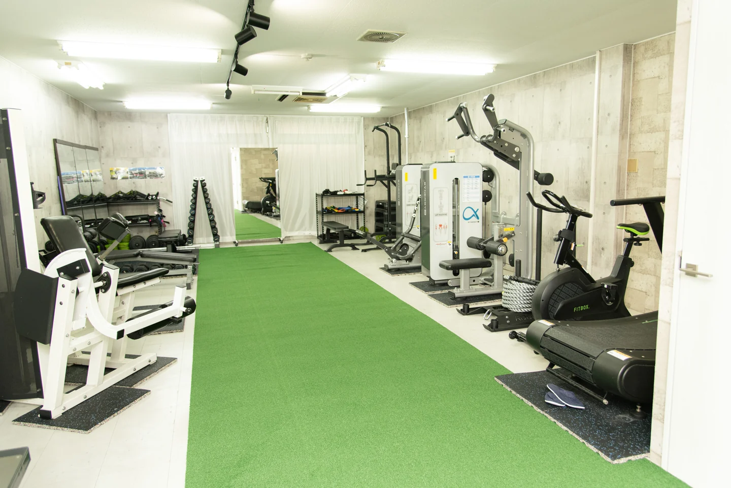 LEPO GYMの人工芝とトレーニングマシンを備えた館内